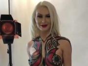 Naked blonde getting body painted