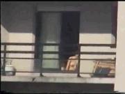 Neighbor sunbathing on balcony