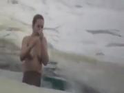 Hot russian woman bathes in the ice-hole