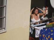 Busty girl enjoying the sun on the balcony