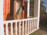 Brunette pissing on a terrace