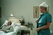Busty nurse tries to put her breasts' nipples on the mouth o