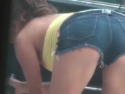 Busty teen in sexy outfit washing car