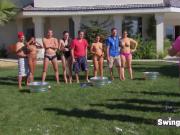 Swingers get naked wet and slippery in a funny sex game in the yard before having intense pleasure