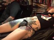 Marie Bossette touches herself while being tattooed