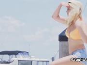 Blowing bikini babe in a boat