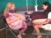 Two gorgeous babes with huge tits play rubbing their ti