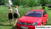 Chicks washing the car outdoors