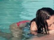 Sensual brunette babe giving a hot blowjob in the pool