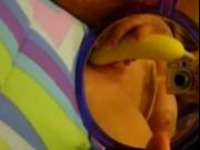 Shaved blonde teen masturbating with a banana