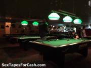 Nasty brunette in a pub is playing pool with her boyfri