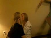 Two cute drunk teens kissing at a party