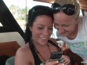 Skanky blond honey and her dark haired pal board a yach