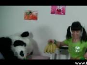 Cute brunette teen has fun with fruit before sucking a