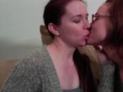 Two brunette lesbians get horny making out on the couch