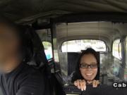 Brunette with glasses gags in fake taxi in public