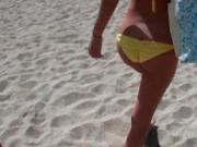 Blonde MILF in swim suit seducing teen guy at beach