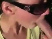 She sucks dick outdoors and eats cum out of a condom