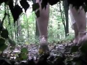 Voyeur is spying and recording two girl pissing in the wood