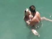 Horny couple having sex on a beach
