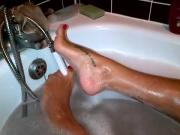 Naked Girl In the Bathtub Uses Her Feet To Play With The Showerhead