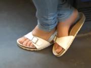 European beauty on train in white sandals