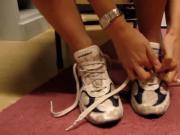 Sniffing stinky white gym sneakers
