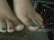 Cute green toe nails on edge of coach