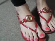 Red flip flops and matching toenails