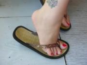 Candid flip-flop fun with red nails