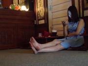 Vietnamese woman uses cellphone while barefoot