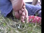 Cute Little Feet Scratch Themselves Outside at a Picnic
