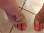 Tattoed feet in seethrough top sandals