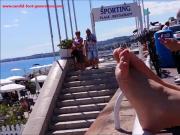 This Woman With Red Toe Nails Relaxes Her Luscious Feet On The Railing At The Beach