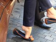 Sophisticated girl enjoys playing with her shoes and voyeur feet in public