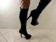 Leather stiletto boots and fishnet stockings