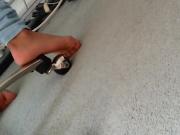 Feet pressing against white carpet