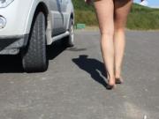 Woman In Short Shorts Walks Around Barefoot Outside On The Pavement