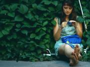 Adorable Brunette Hippy Gal Sits In Shrubs and Shows Off Her Dirty Feet While Smoking