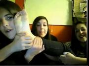 Four young women show feet on webcam
