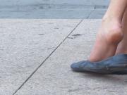 Dangling blue flats over sidewalk