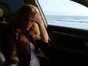 Blond beauty masturbates in the car