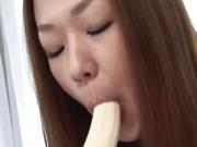 Cute asian teen is sucking back that banana...